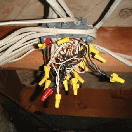 Here's the opposite to the other picture, why use several electrical junction boxes when you can cram everything into one. Does anyone smell something burning?