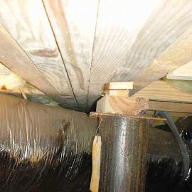 Unfortunately, the main support column for the center floor joists was just two inches short. They thought it would be fine to just jam in a few small scraps of wood they found laying around. That should support the entire floor.