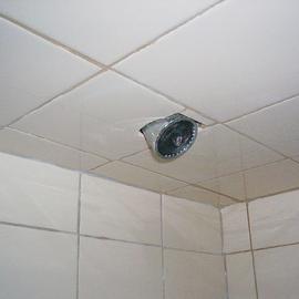 This is the result of lowering the ceiling in your shower when you retiled, without bothering to lower the shower head. I hope they never have to replace that head.